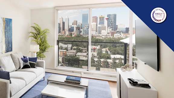 A living room with a large window overlooking a cityscape.