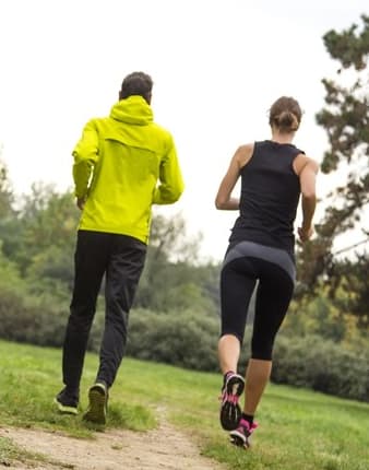 Two people jogging on a trail