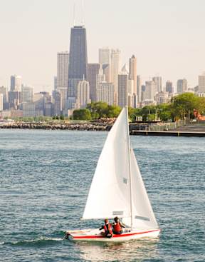 Sailboat at Montrose Harbor with Chicago skyline view near Buena Shores apartments in Buena Park.