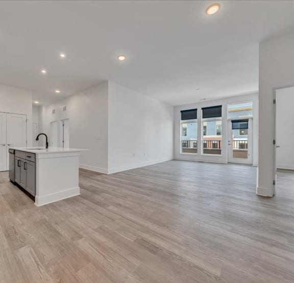 an unfurnished living area with large windows and plank flooring  at Luxe 360 on Centerpointe Apartments, Midlothian, VA, 23114