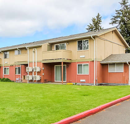 Apartment complex with a red curb in front.