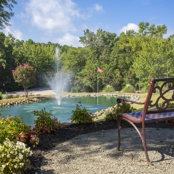 a bench sits in front of a fountain