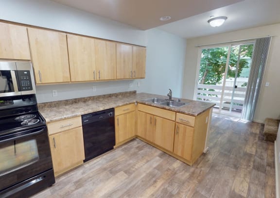 a kitchen with wooden cabinets and stainless steel appliances