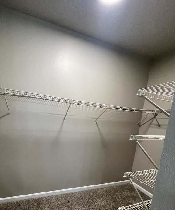 A metal staircase with a grey wall in the background.