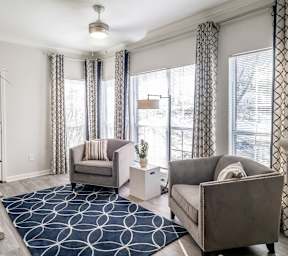 A living room with a black couch and a fireplace. at Lincoln at Wolfchase Apartments, Tennessee