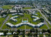 Thumbnail 20 of 25 - an aerial view of a city with a park and buildings