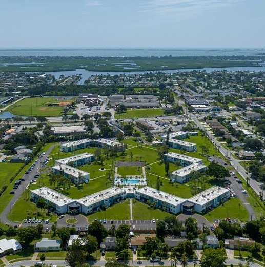 an aerial view of a city with a park and buildings