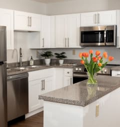 a kitchen with a white refrigerator freezer next to a white stove top oven