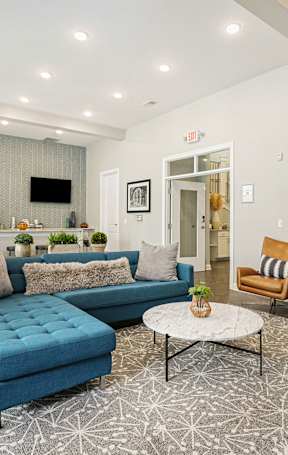 A living room with a blue sofa and a coffee table.