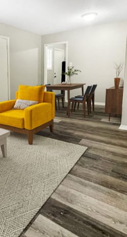 a living room with a yellow chair and a table at The Junction, Tennessee, 38111