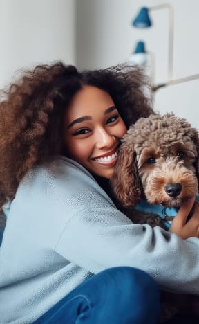 a woman sitting on a couch with her dog
