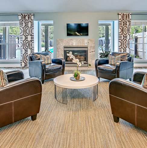 A living room with a fireplace and a television.
