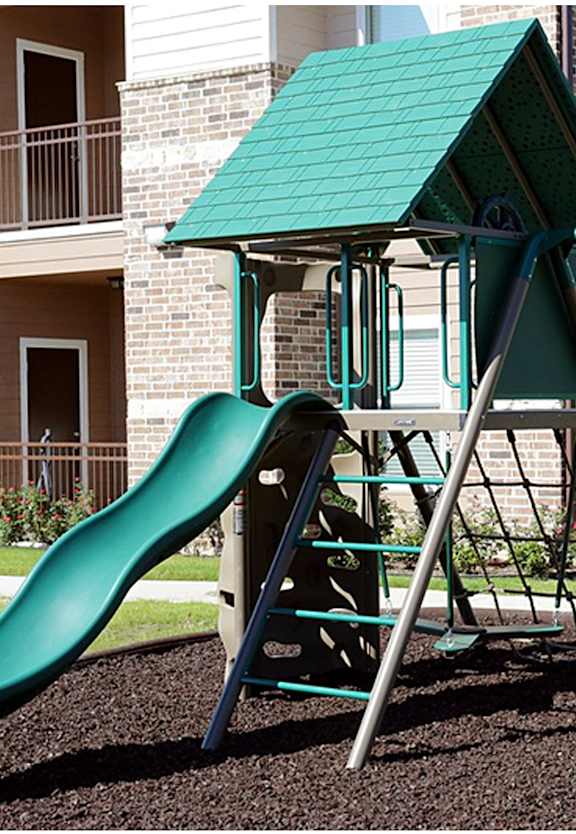 a playground with two slides at Cypress Creek Apartment