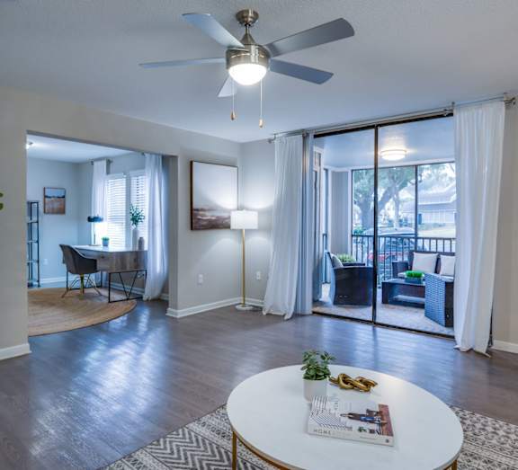 a bedroom with a bed and a ceiling fan