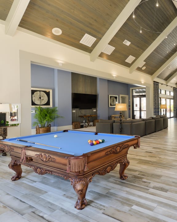 a spacious game room with a pool table and a bar at Cabana Club Apartments in Jacksonville Florida