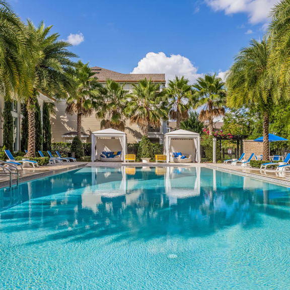 Exterior pool view at Sancerre at Sand Lake with cabanas and lounge chairs