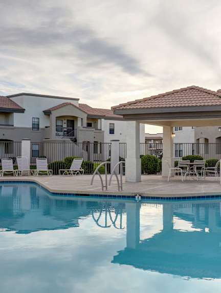 A house with a fountain in front of it.