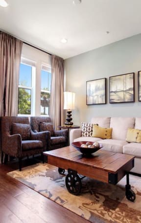 a living room with a couch and a table at The Vines at Riverpark, LLC, Oxnard, CA