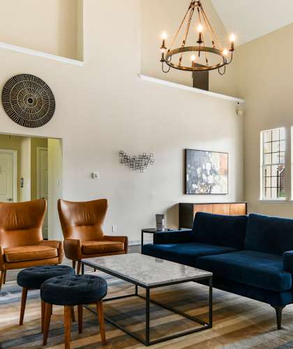 A living room with a blue couch and a wooden coffee table.