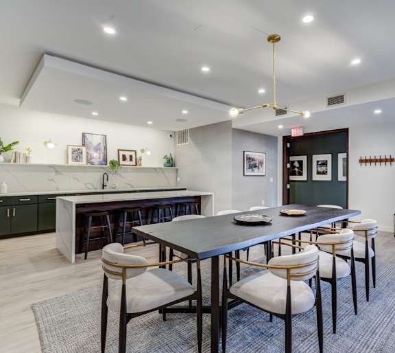A modern dining room with a large table and chairs.