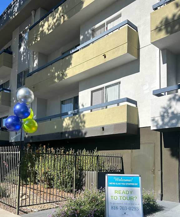 a view from above of a building with balloons on the ground