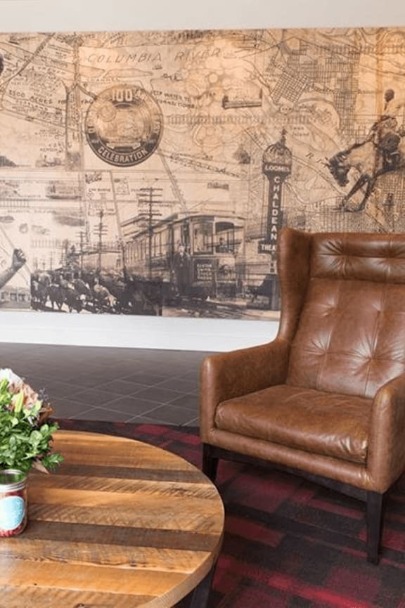 A living room with a brown leather couch and a coffee table.
