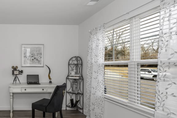 a home office with a desk and a couch in a 555 waverly unit at Hilltop Apartments, Cincinnati