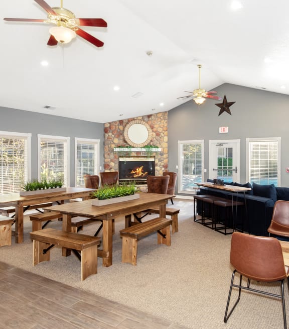 Hathaway Court Clubhouse seating area, fireplace, tables and chairs 