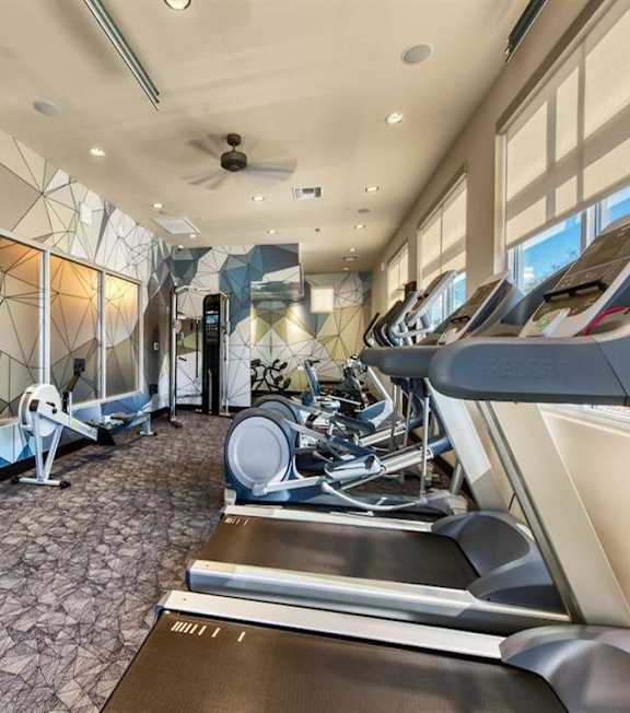 A gym with treadmills and elliptical machines. at Craft at Gilbert and Baseline Apartments, Arizona, 85204