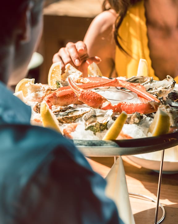 A couple enjoying a seafood meal together.