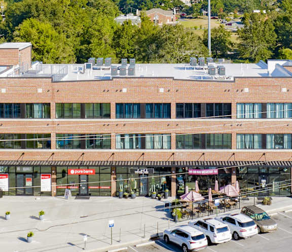 A large building with a parking lot in front of it.
