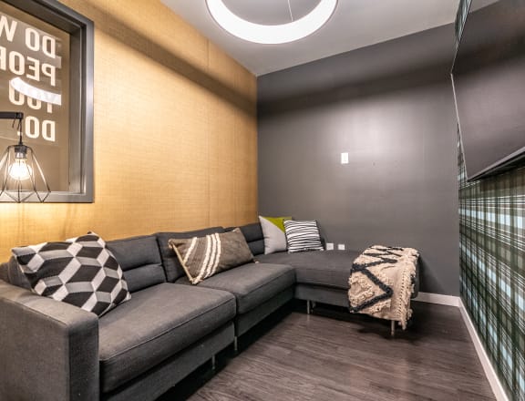 a living room with a gray couch and pillows