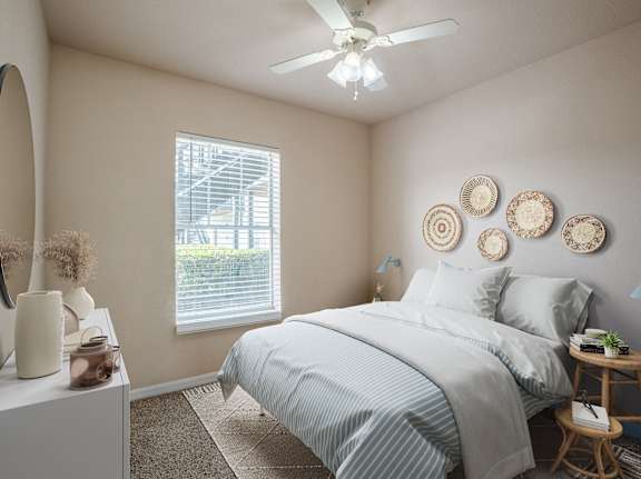 a bedroom with a bed and a ceiling fan