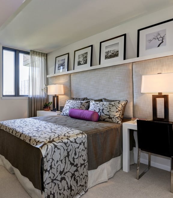 a bedroom with a bed and a desk with a chair