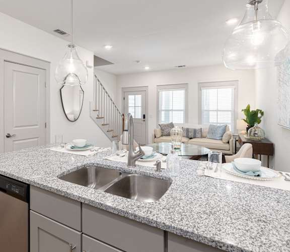 A modern kitchen with granite countertops and stainless steel appliances.