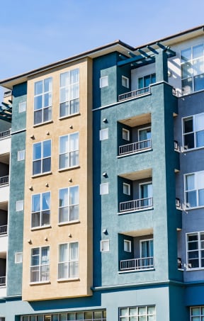 the exterior of an apartment building with many windows