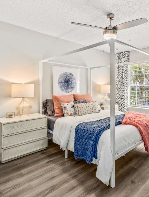 A bedroom with a bed, dresser, and mirror.at Coastline Apartments, Fort Walton Beach, FL 32547