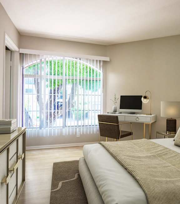 a bedroom with a bed and a sliding glass door