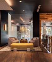 A large room with a staircase and a lot of windows.