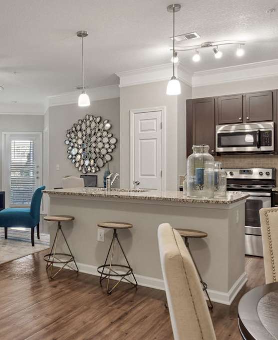 a kitchen and dining room area with a table and chairs and a counter at Echo at Lake Norman, Mooresville, NC