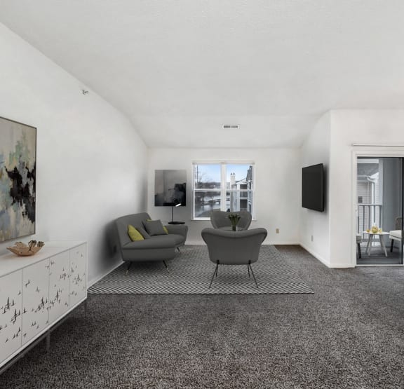 the living room and dining area of an apartment with white walls and carpet and furniture WaterFront Apartments, Virginia Beach