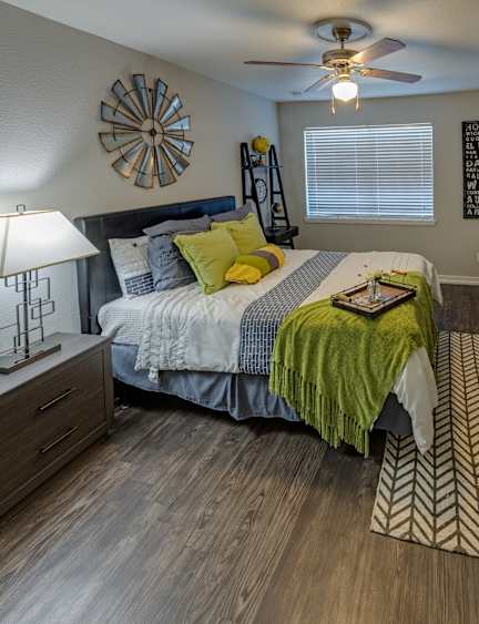 A bedroom with a bed, dresser, and mirror.