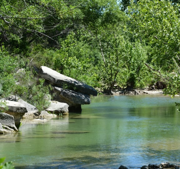Barton Creek in Austin, Texas with rocks and trees lining creek