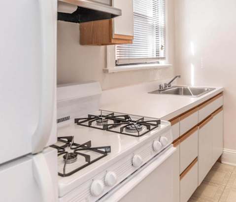 a kitchen with a stove and a sink and a refrigerator