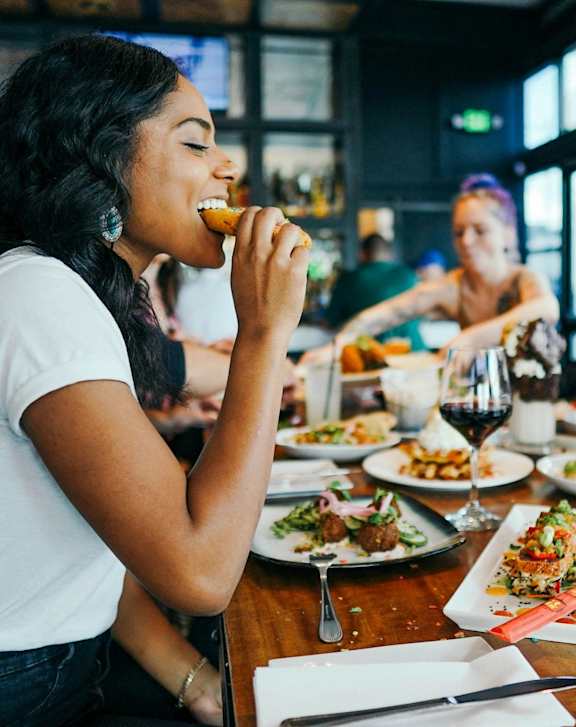 Woman Eating in Restaurant