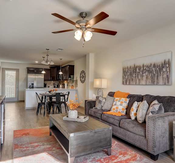 a living room and kitchen with a couch and a table