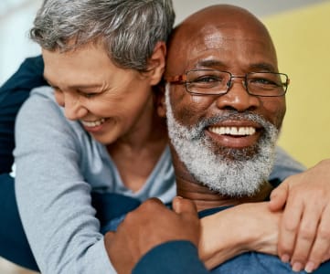 Elderly Woman Hugging Elderly Man