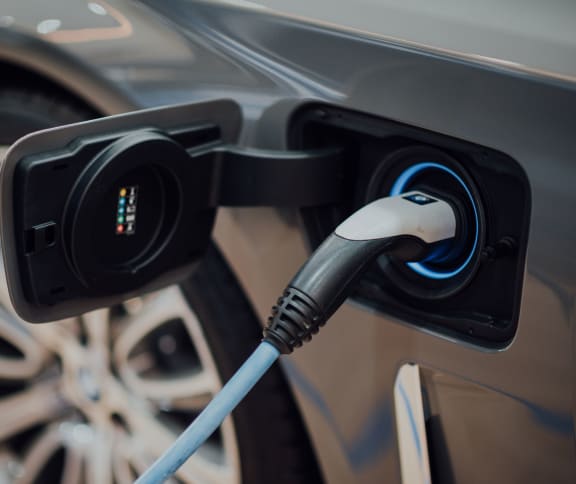 an electric car is plugged into a charging station
