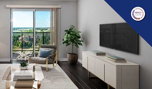 A modern living room with a large window overlooking a balcony.
