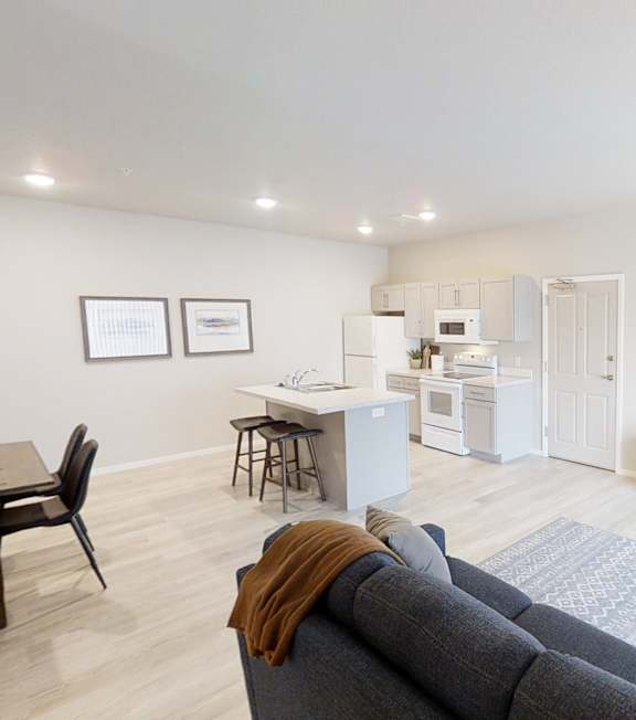 A bedroom with a bed, nightstand, and two pictures on the wall.